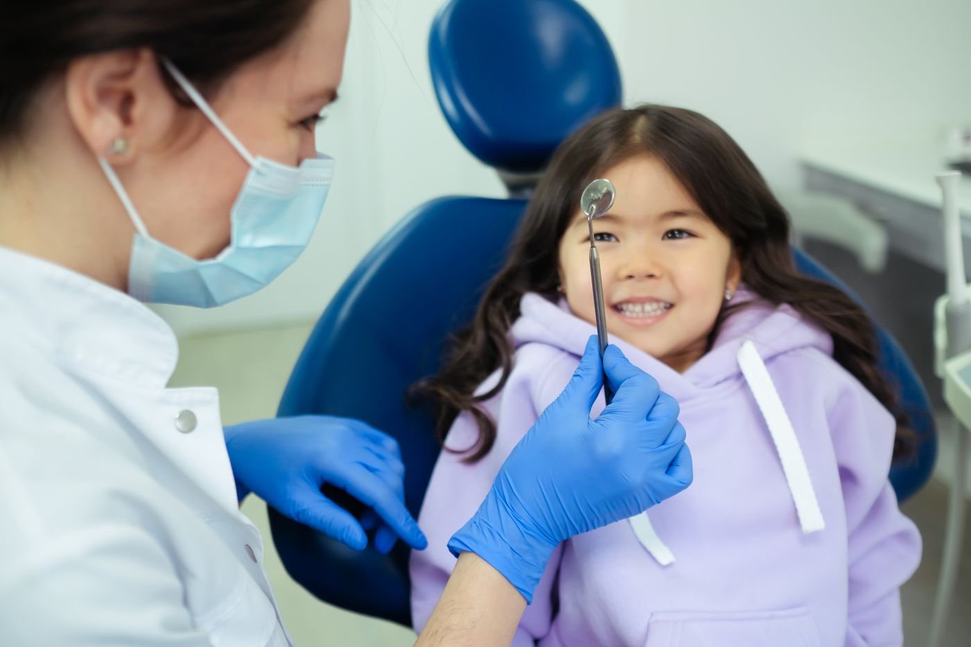 A dentist with a smiling young patient
